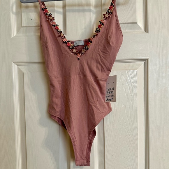 Luxe Tops - Luxe dusty pink bodysuit with floral accents. NWT
